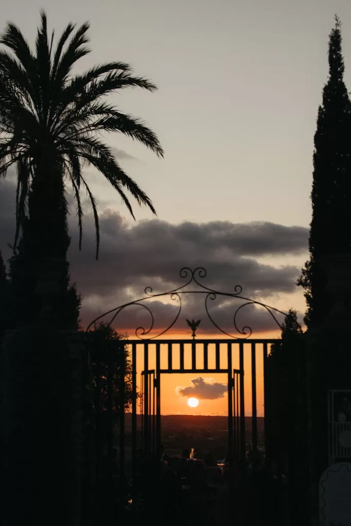 Sunset view through the ornate iron gate at Finca Son Collell