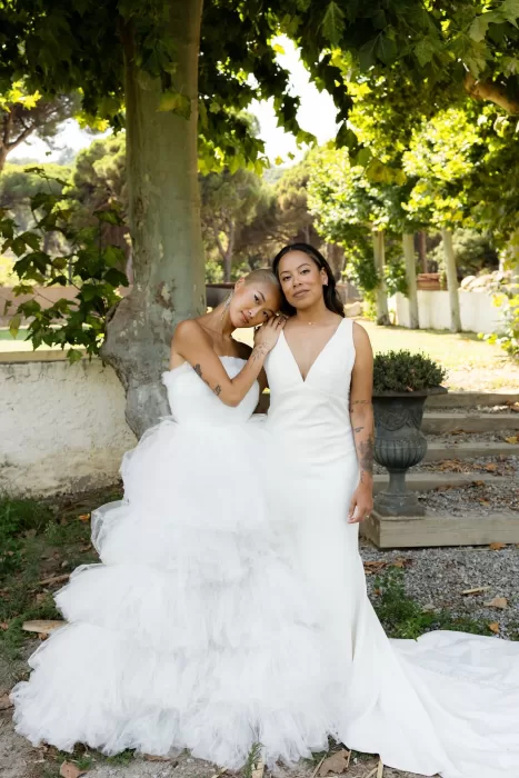 Brides posing together under shaded trees in the lush gardens of La Finka 4.1.
