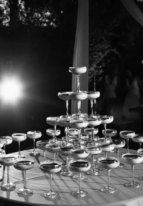 Black-and-white photo of a champagne tower at La Finka 4.1 wedding celebration.