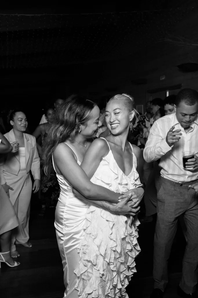 Brides laughing and dancing together on the lively dancefloor at La Finka 4.1.