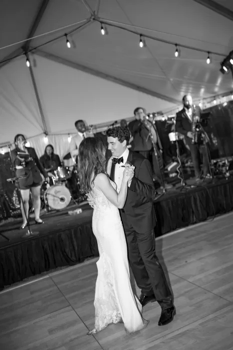 Bride and groom sharing their first dance under string lights at Laguna Gloria.