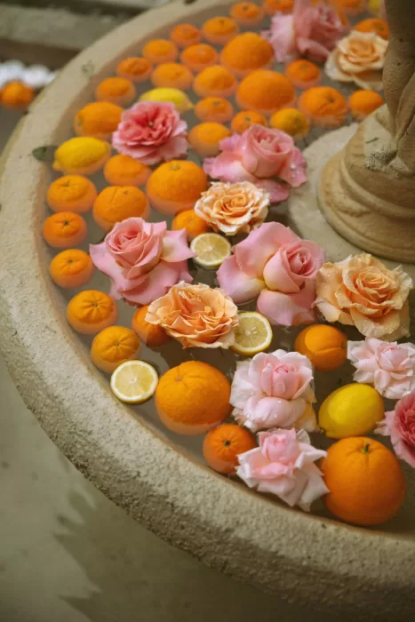 Floating oranges, lemons, and pink roses decorating a fountain at Laguna Gloria.