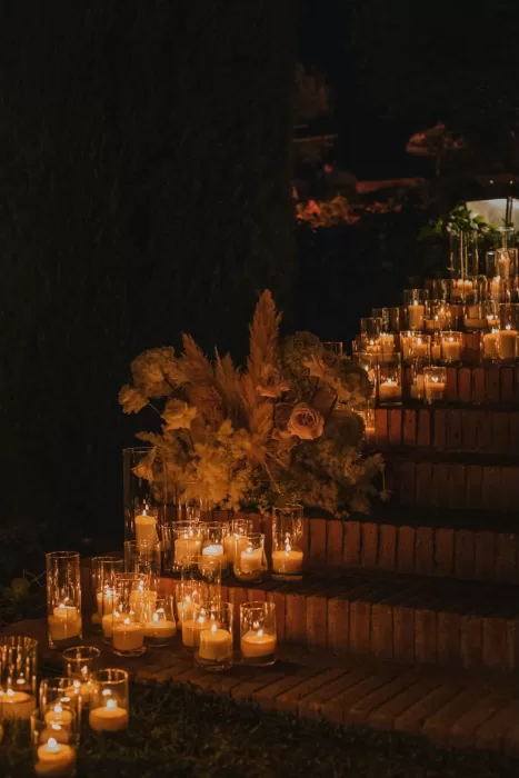 Romantic candlelit staircase decorated with flowers at Mas de Les Voltes wedding.