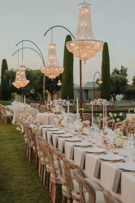 Long banquet table with floral décor and chandeliers at Mas de Les Voltes.