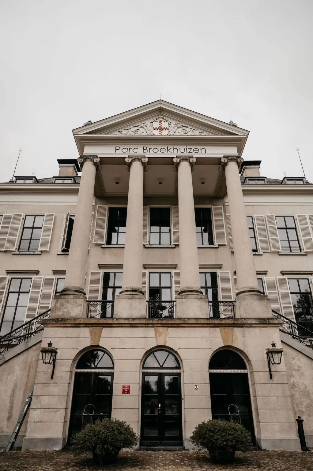 Close-up of the grand entrance and columns of Parc Broekhuizen.
