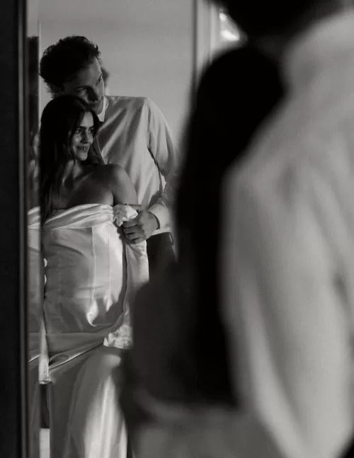 Bride and groom reflected in a mirror, sharing an intimate embrace at Stone Haven.