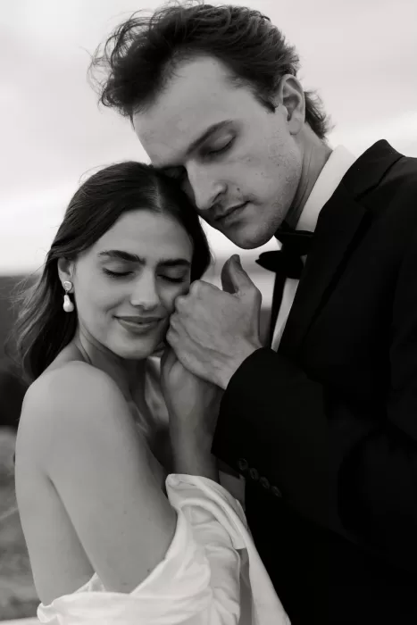 Romantic black and white closeup of the couple embracing tenderly at Stone Haven.