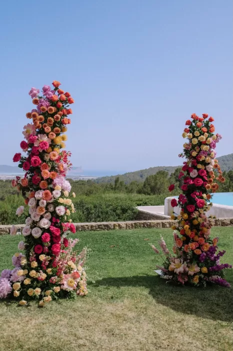 Vibrant flower pillars overlooking the sea at Villa Blue Star Ibiza ceremony space.
