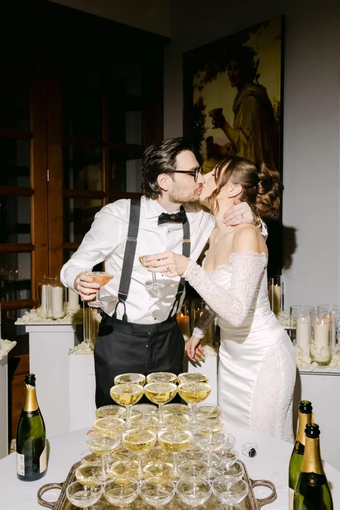 Bride and groom celebrate with a champagne tower toast inside Château de Jalesnes.