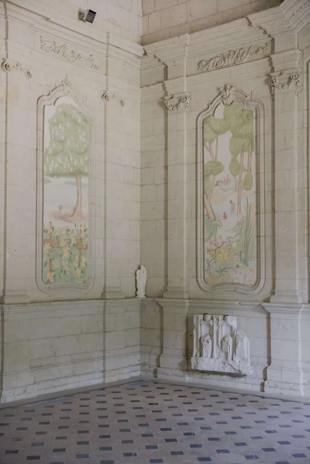 Delicate painted wall panels and stone carvings inside the chapel at Château de Jalesnes.