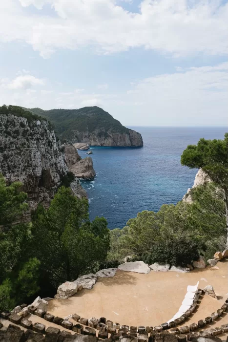 Cliffside terrace overlooking the sea at Hacienda Na Xamena, set for an outdoor wedding ceremony.