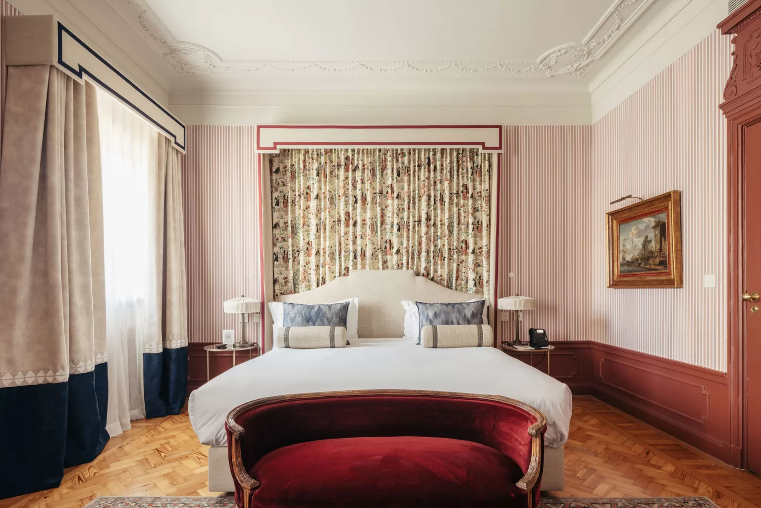 Deluxe guest room at Hospes Infante Sagres with neutral tones, modern furniture, and warm natural light.