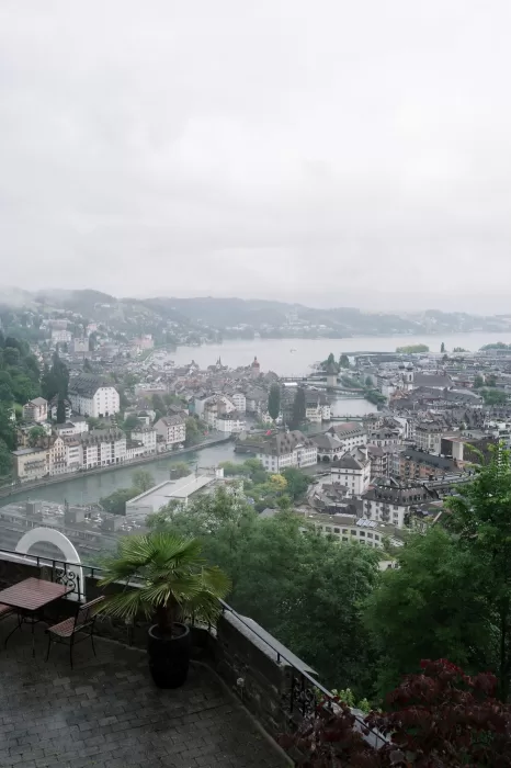 Misty morning view from Hotel Château Gütsch overlooking the rooftops and lake of Lucerne.