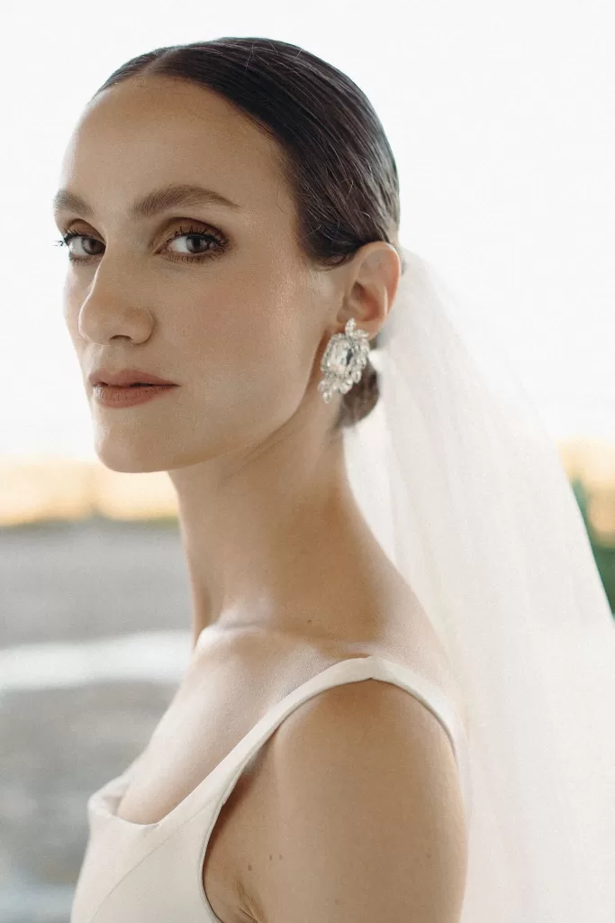 Soft bridal portrait showcasing the bride’s elegant makeup and earrings at Masseria Spina.