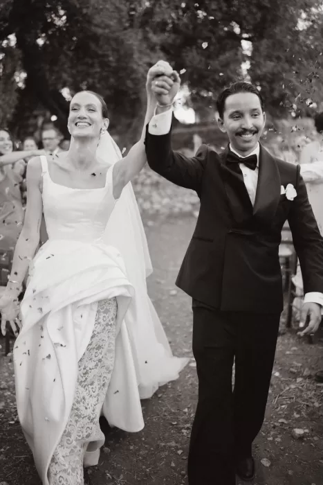 Joyful confetti exit as the newlyweds walk hand in hand at Masseria Spina.