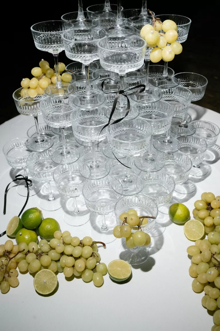 A crystal champagne tower at Apulien Bari adorned with grapes and citrus, ready for the evening celebration.