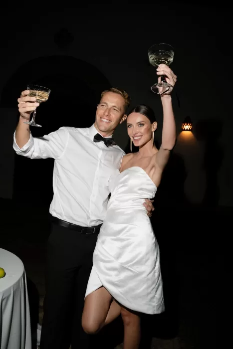 The couple raising their glasses in celebration at Apulien Bari during their evening reception.