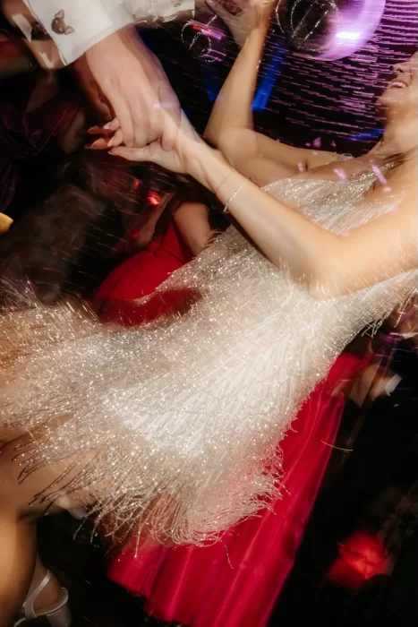 Bride dancing joyfully on the evening dance floor at Areias do Seixo, captured with motion and light.