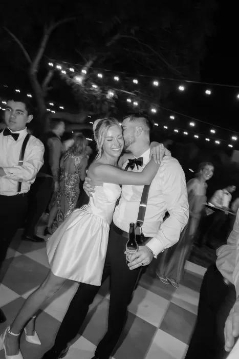 Bride and groom embracing on the dance floor at Baja Luna during the evening celebration.