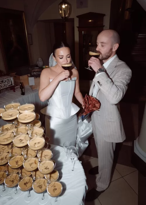 Bride and groom sharing cocktails during their Malpils Manor wedding celebration, captured in a relaxed and intimate moment.