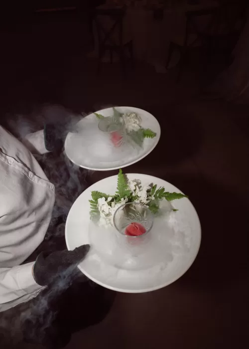 Wedding dessert being served with dramatic dry ice presentation at Malpils Manor, adding a theatrical touch to the evening.