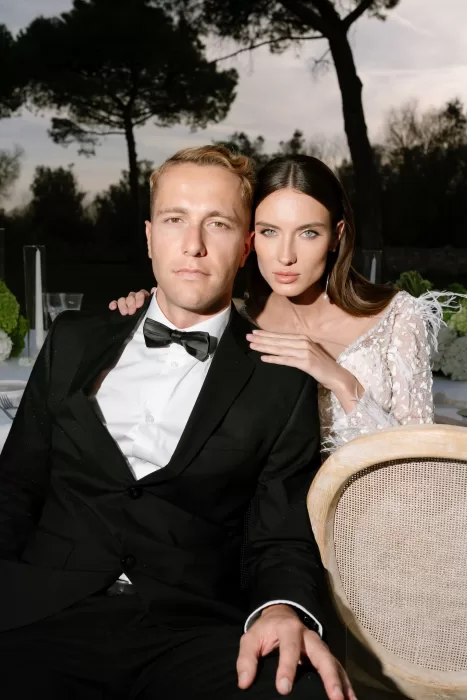 A close, intimate portrait of the bride and groom at Masseria, seated together during golden hour.