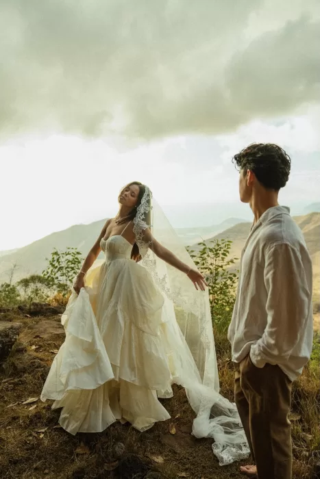 Bride moving freely in her flowing dress with mountain scenery behind her at Ossipoff’s Cabin.