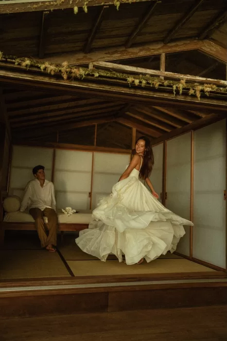 Bride twirling in a flowing wedding dress inside the wooden cabin interior at Ossipoff’s Cabin, full of movement and ease.
