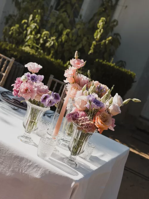 Romantic table styling with pastel florals and glassware in the gardens of Vandelli Botanical Garden.