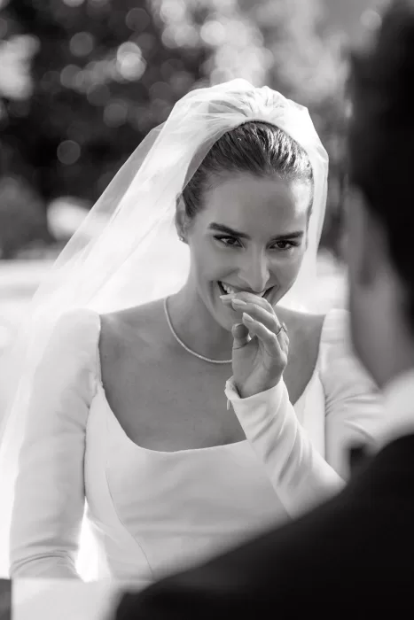 Black and white portrait of the bride laughing softly during the ceremony at Villa Lario Resort