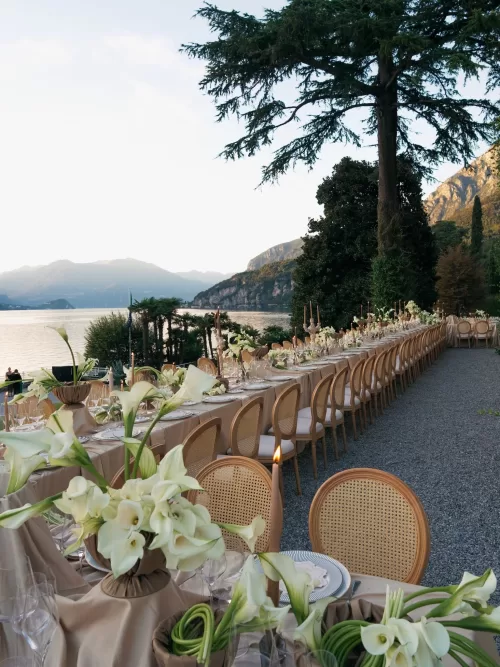 Long lakeside wedding dinner table styled with calla lilies at Villa Lario Resort