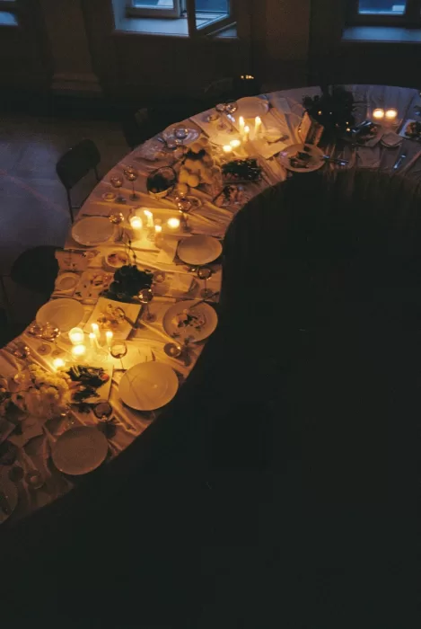 Overhead view of a candlelit wedding table set for an intimate evening reception, creating a warm and cinematic atmosphere.