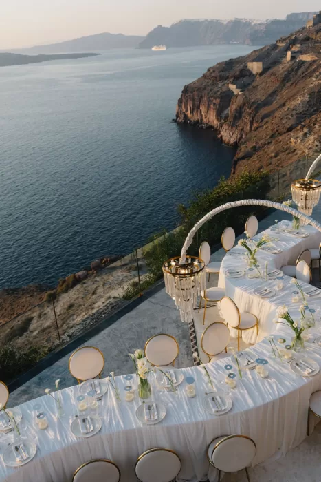 Overhead view of a curved wedding reception table at Cavo Ventus with candlelight, floral styling and panoramic sea views.