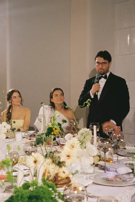 Groom giving an emotional wedding speech during an elegant candlelit reception, photographed in an editorial fine art style by Alexa Curly.