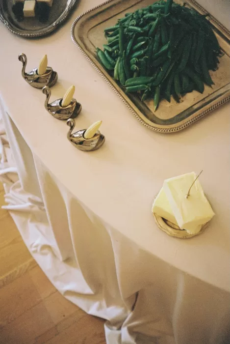 Editorial wedding table details featuring sculptural silver serveware, soft linen textures, and an intimate fine art aesthetic.