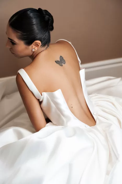 Close-up of the bride’s open-back wedding dress, capturing soft light and intimate details at Finca La Concepción.