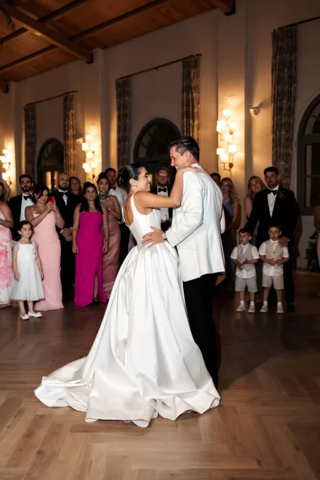 Bride and groom sharing their first dance surrounded by guests inside Finca La Concepción’s reception hall.