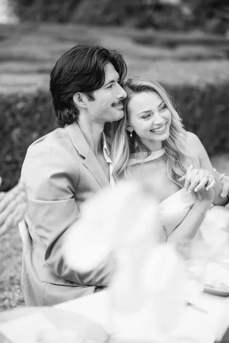 Black and white portrait of the bride and groom seated together at Fontsanta, capturing intimacy and ease.