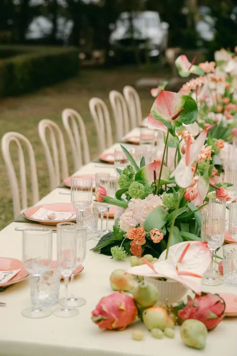 Close-up of wedding table flowers and glassware at Fontsanta with soft green and blush tones.