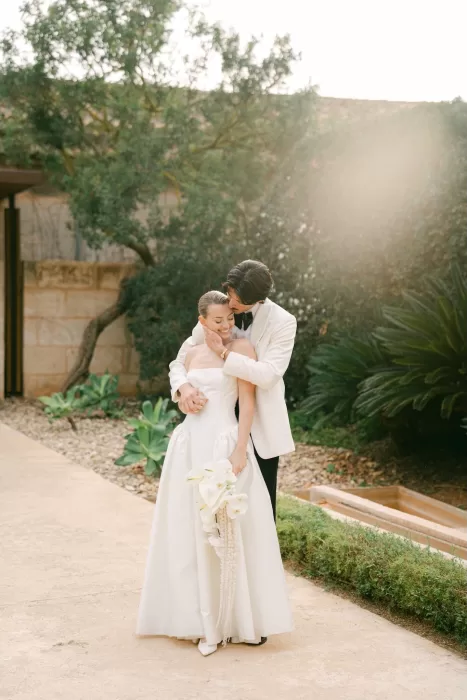 Romantic garden portrait of the bride and groom at Fontsanta with soft light and Mediterranean greenery.