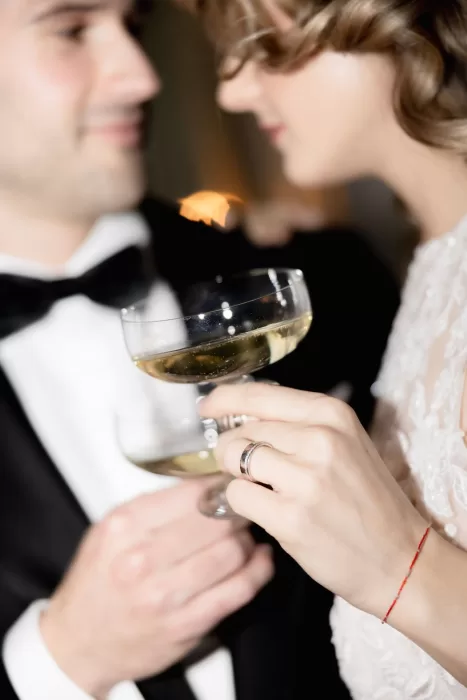 Close-up of the bride and groom sharing champagne during their wedding reception at Grand Hotel du Lac.