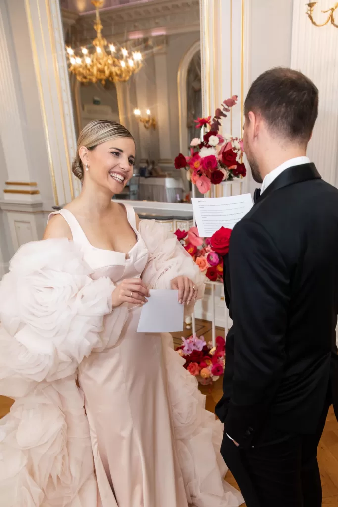 Bride smiling as she reads her vows during an intimate indoor ceremony at Grand Hotel du Lac.