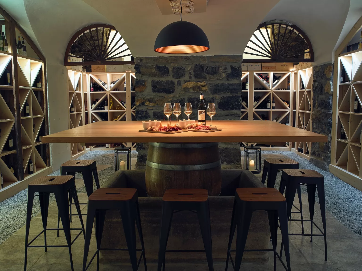 Intimate wine cellar at Grand Hotel du Lac styled with candlelight, wine glasses and a refined tasting table.