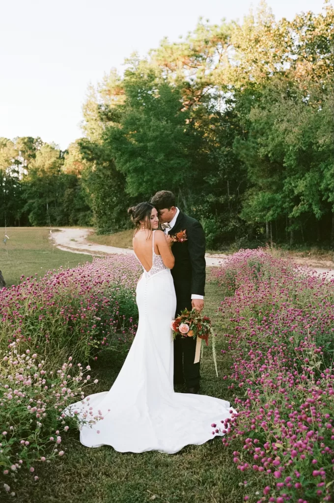 Romantic couple portraits taken in a wildflower field at The Greenhouse at Arrows Farm during golden hour.