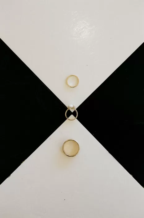 Wedding rings styled on a geometric surface at The Greenhouse at Arrows Farm, captured in a clean, modern detail shot.