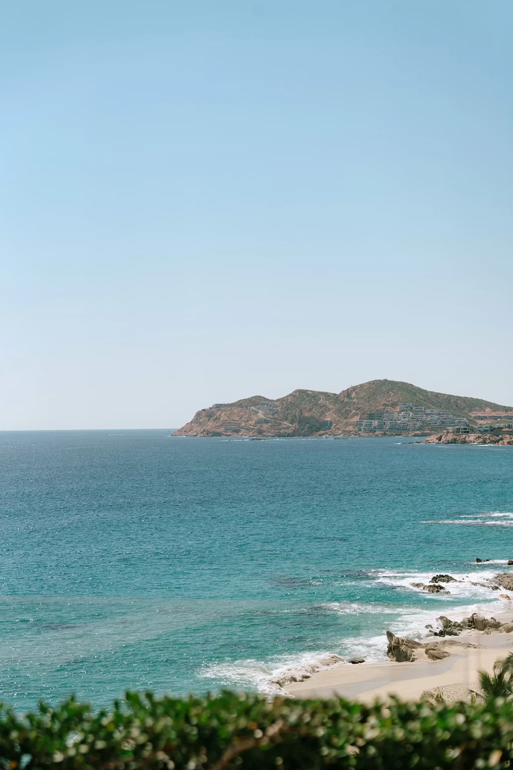 Panoramic ocean view near Baja Luna with turquoise water, sandy beach and coastal cliffs.