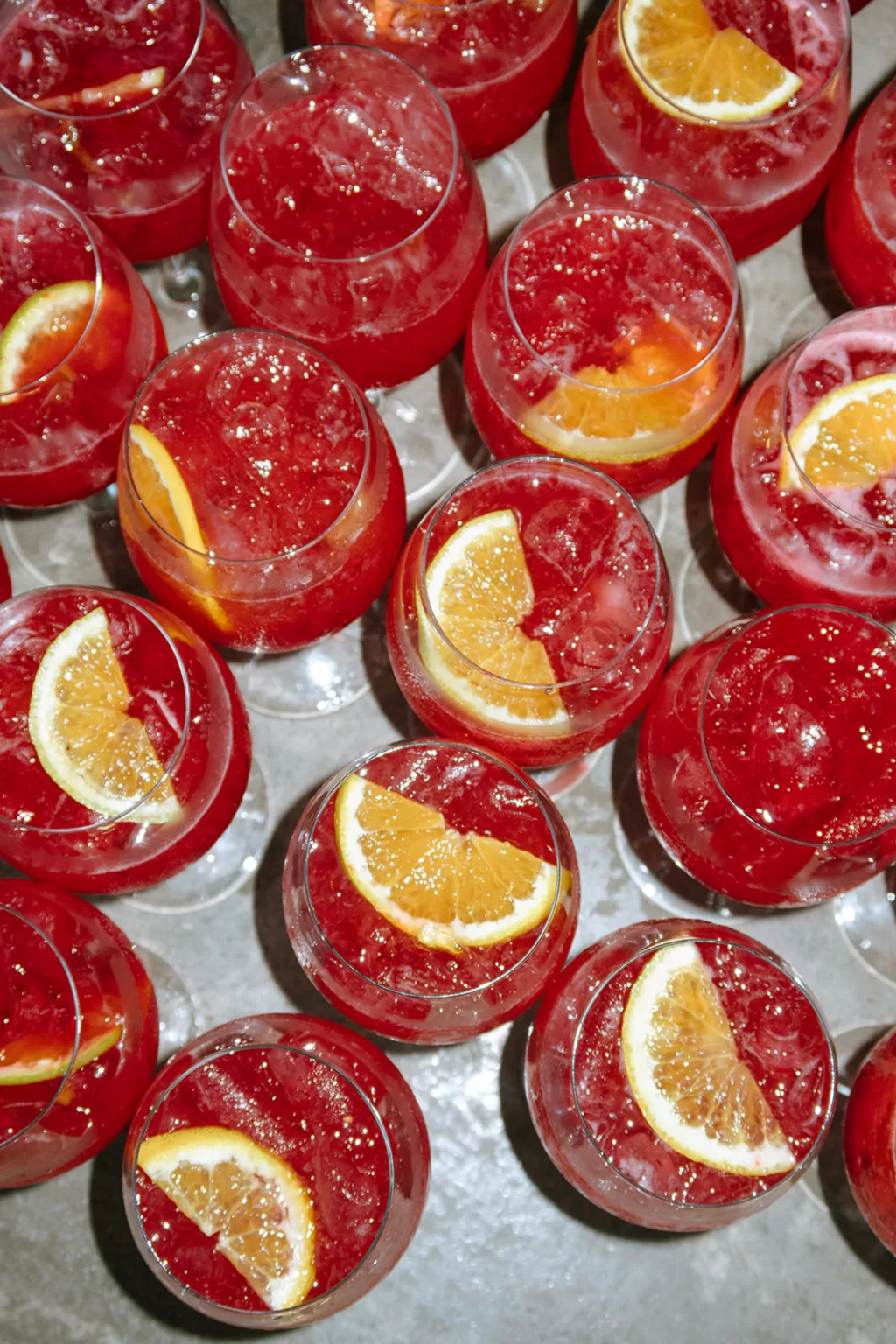 Red citrus cocktails prepared for wedding guests at Baja Luna, styled as refreshing welcome drinks.