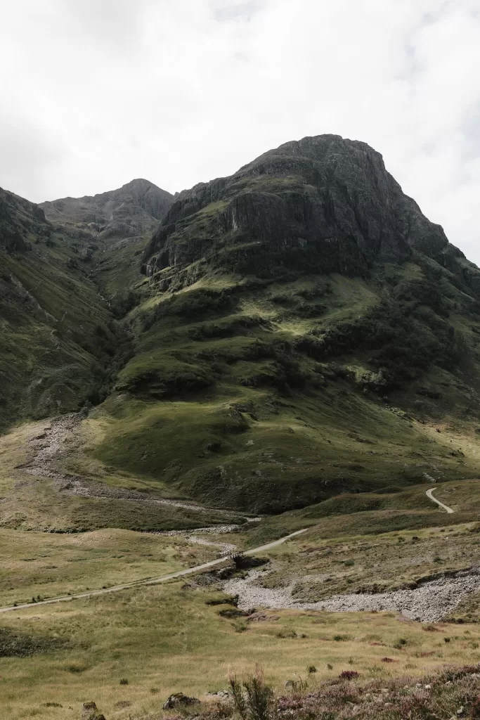 Moody Scottish landscape of rolling hills and valleys surrounding Boturich Castle.