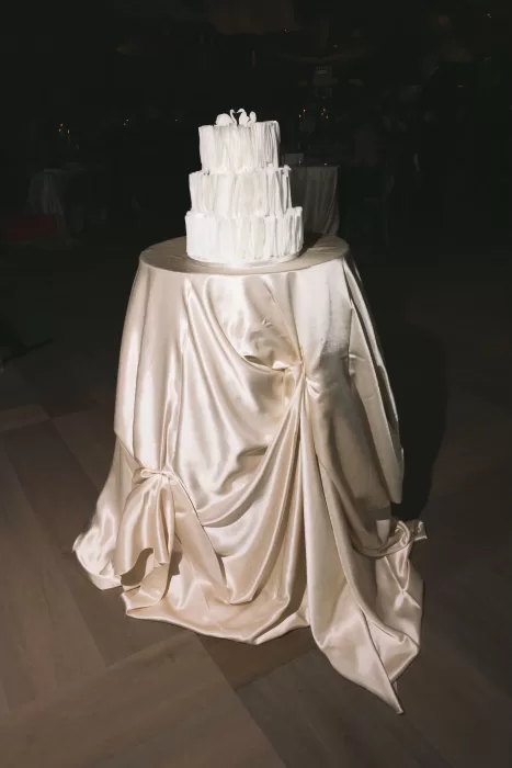 White tiered wedding cake displayed during the evening reception at Boturich Castle.