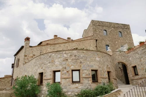 Historic stone architecture and courtyard exterior of Castello di Velona wedding venue.